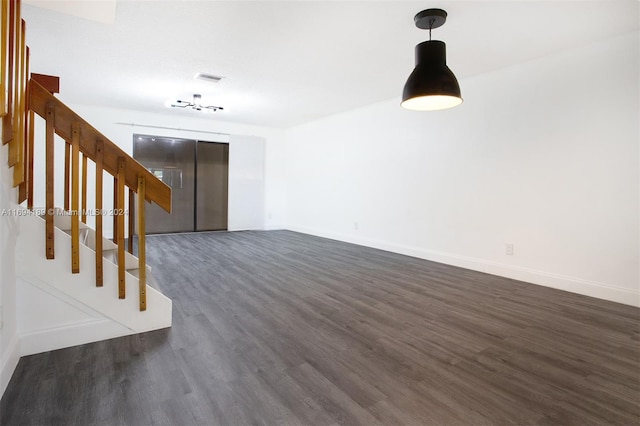 unfurnished living room with dark wood-type flooring