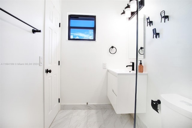 bathroom featuring vanity and toilet