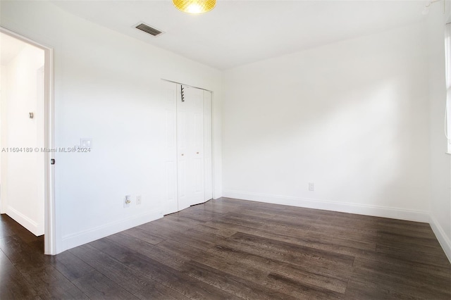 interior space with dark hardwood / wood-style floors and a closet