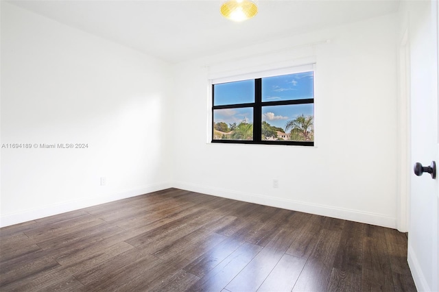 unfurnished room featuring dark wood-type flooring