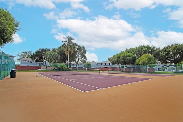 view of tennis court with basketball hoop