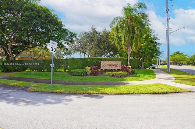 community / neighborhood sign featuring a yard