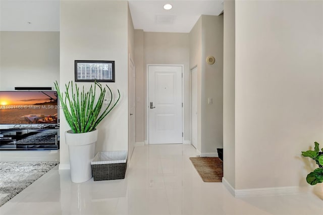 hall with light tile patterned flooring