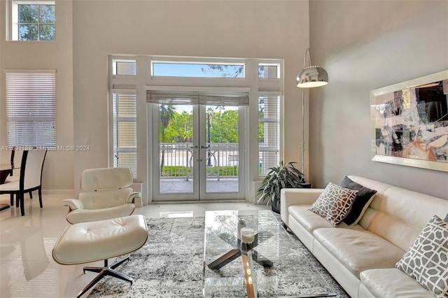 living room with french doors and a high ceiling