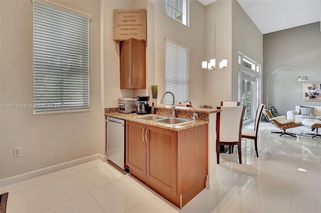 450 N Federal Hwy Unit 104N, Boynton Beach, FL 33435 - kitchen with a sink, dishwasher, healthy amount of natural light, a towering ceiling, and light stone counters