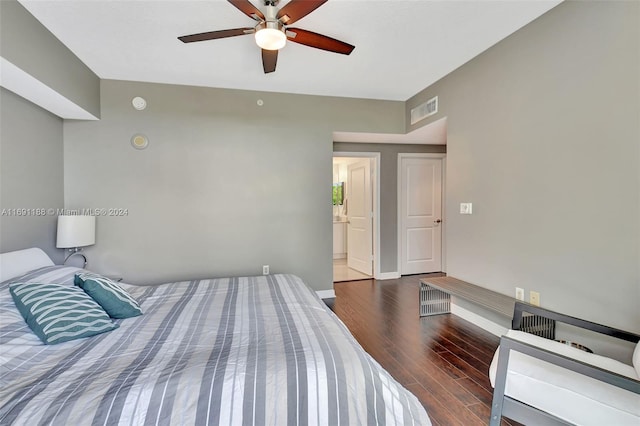 bedroom with ensuite bath, ceiling fan, and dark wood-type flooring