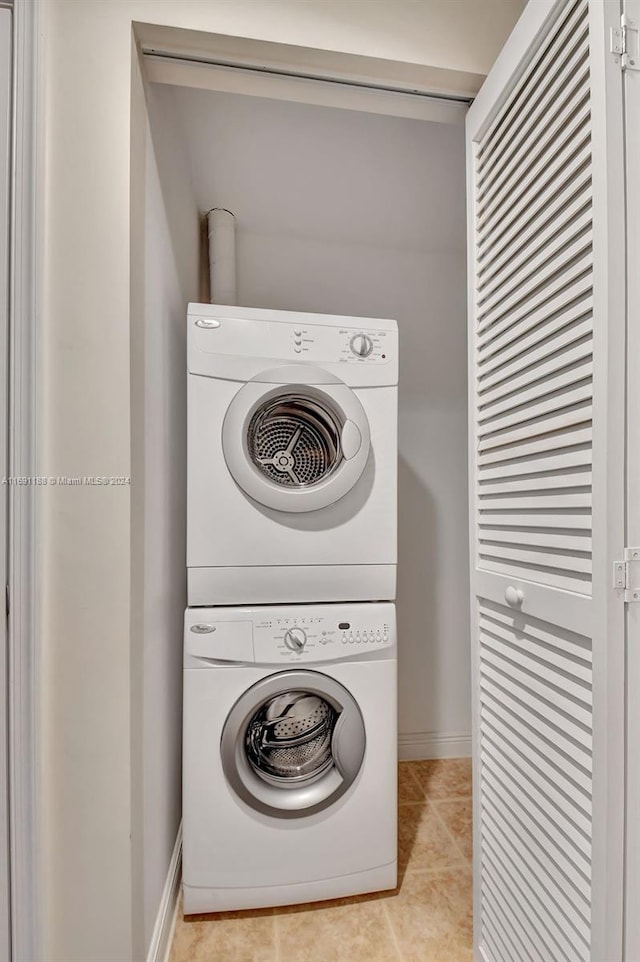 450 N Federal Hwy Unit 104N, Boynton Beach, FL 33435 - washroom with stacked washer / dryer, baseboards, and light tile patterned floors