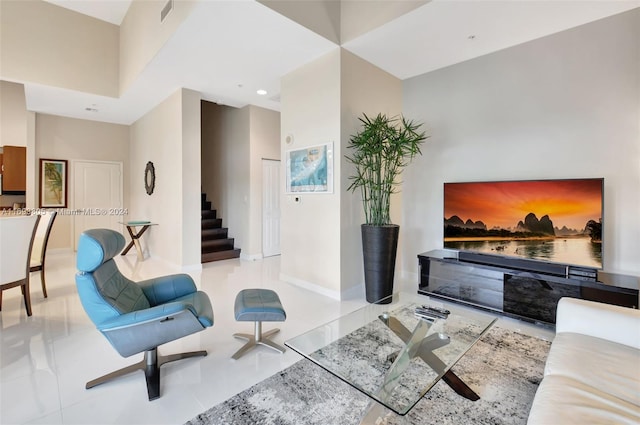 tiled living room featuring a high ceiling