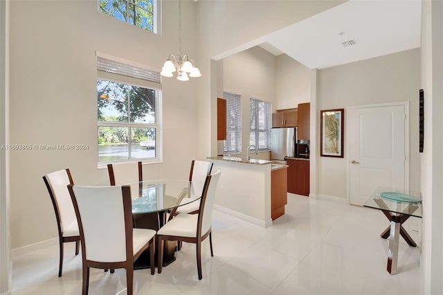 dining area featuring light tile patterned flooring and a chandelier