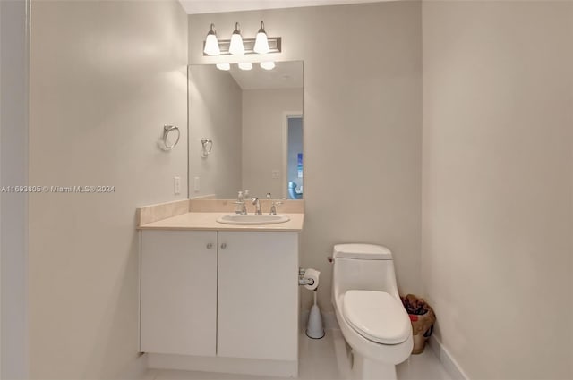 bathroom featuring tile patterned floors, vanity, and toilet