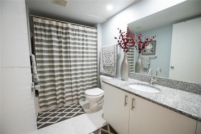 bathroom with tile patterned floors, vanity, and toilet