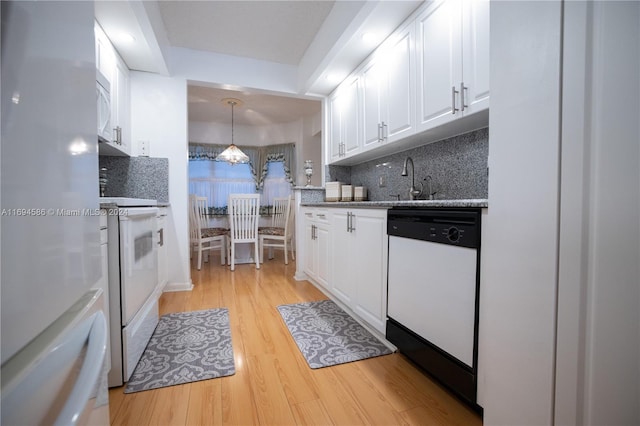 kitchen with white cabinetry, pendant lighting, light hardwood / wood-style floors, and white appliances