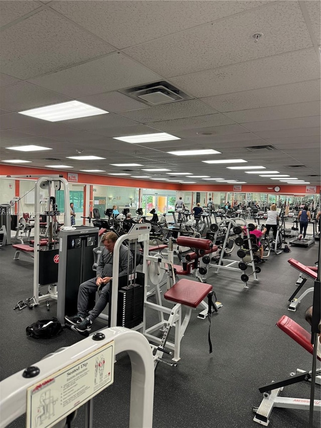 exercise room featuring a paneled ceiling