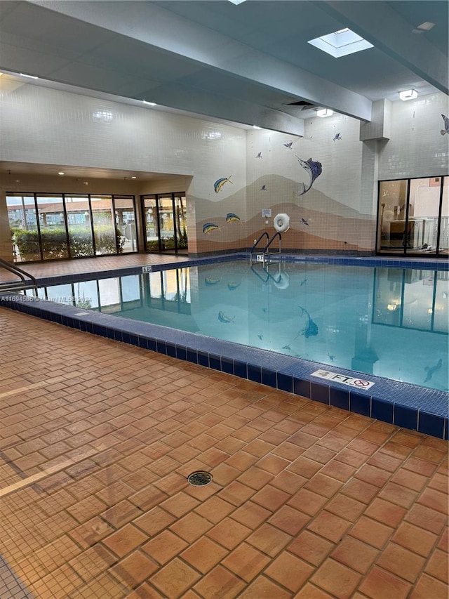 view of pool featuring a skylight