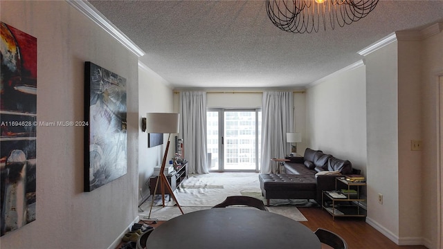 living room featuring hardwood / wood-style floors, a textured ceiling, and crown molding