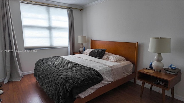 bedroom featuring dark hardwood / wood-style floors and ornamental molding