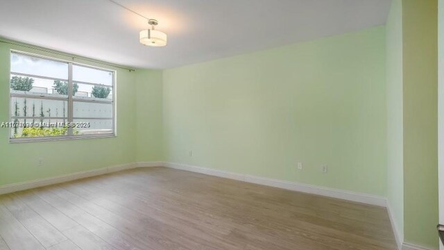 unfurnished room with light hardwood / wood-style floors