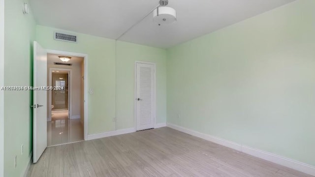 unfurnished bedroom with light hardwood / wood-style floors and a closet