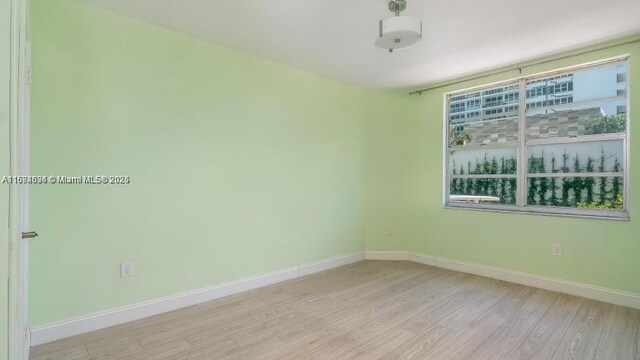 spare room with light wood-type flooring