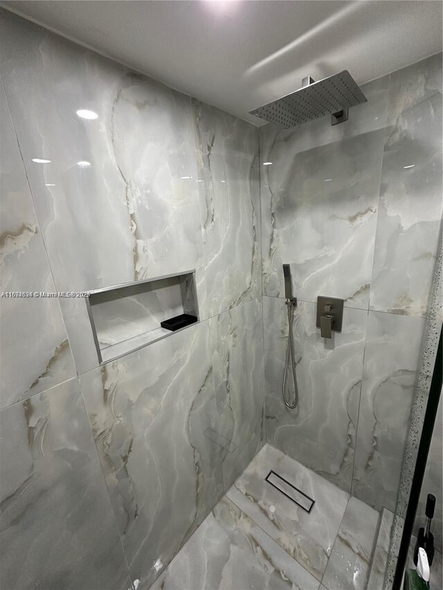 bathroom featuring toilet and tile walls