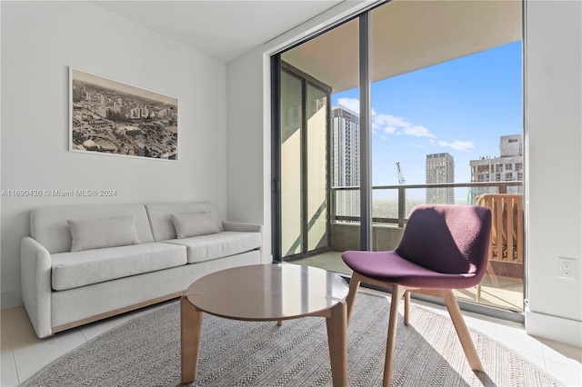 living room with tile patterned flooring, plenty of natural light, and floor to ceiling windows