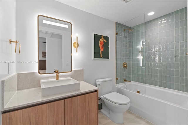 full bathroom featuring tile patterned flooring, vanity, toilet, and tiled shower / bath