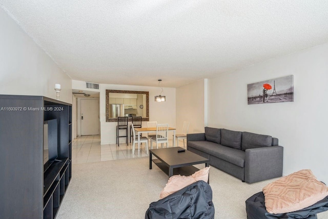 living room with light carpet and a textured ceiling