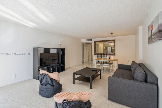 living room with light colored carpet and a textured ceiling