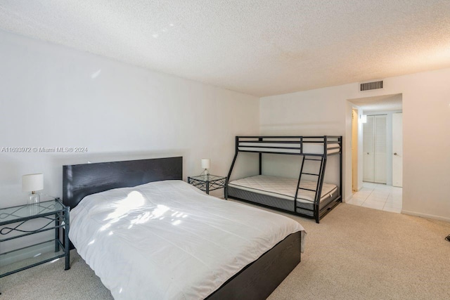 carpeted bedroom featuring a textured ceiling