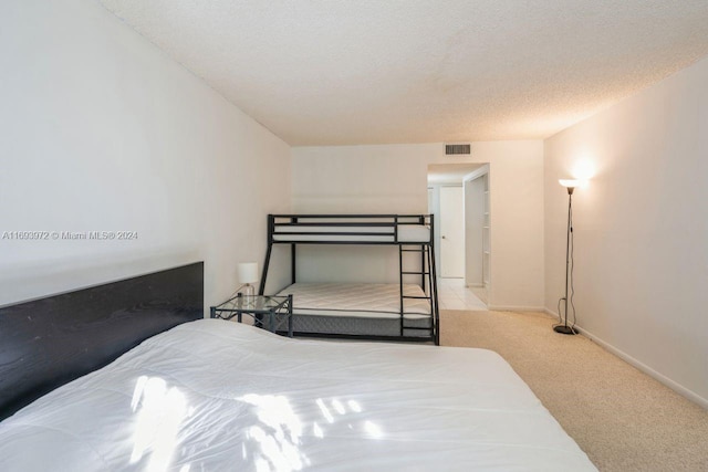 carpeted bedroom featuring a textured ceiling