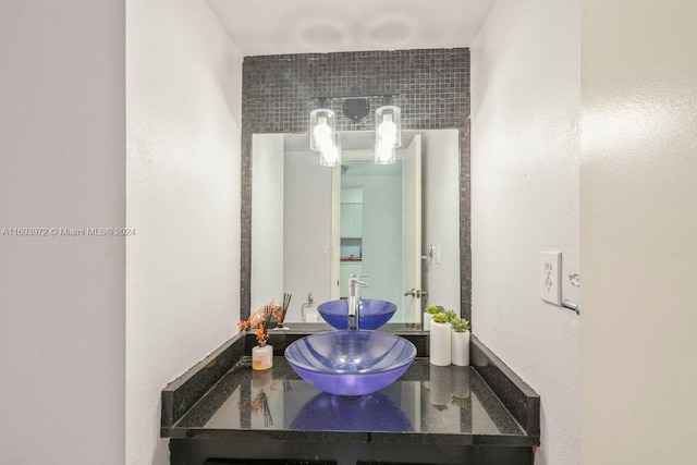 bathroom with tasteful backsplash and vanity