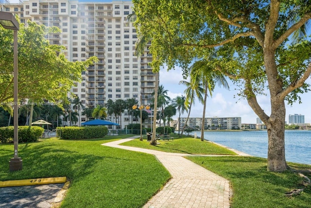 view of home's community featuring a yard and a water view