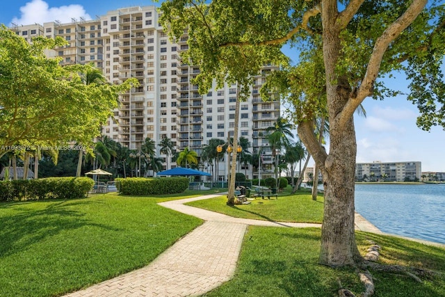 view of property's community featuring a yard and a water view