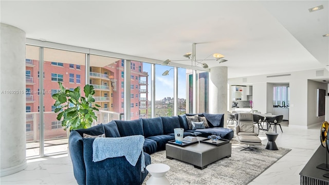 living room with a wall of windows and an inviting chandelier