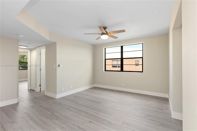 unfurnished room featuring light hardwood / wood-style flooring and ceiling fan