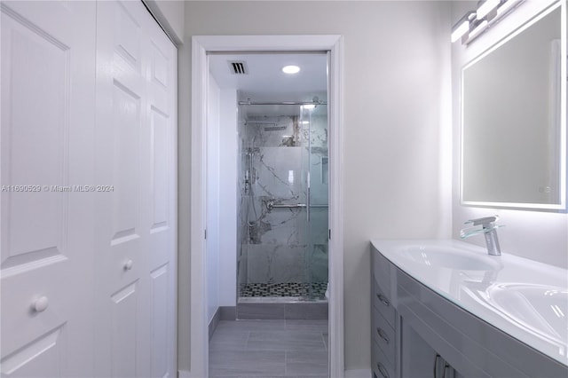 bathroom with vanity and a shower with shower door