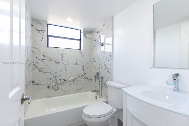 full bathroom featuring vanity, tiled shower / bath combo, and toilet