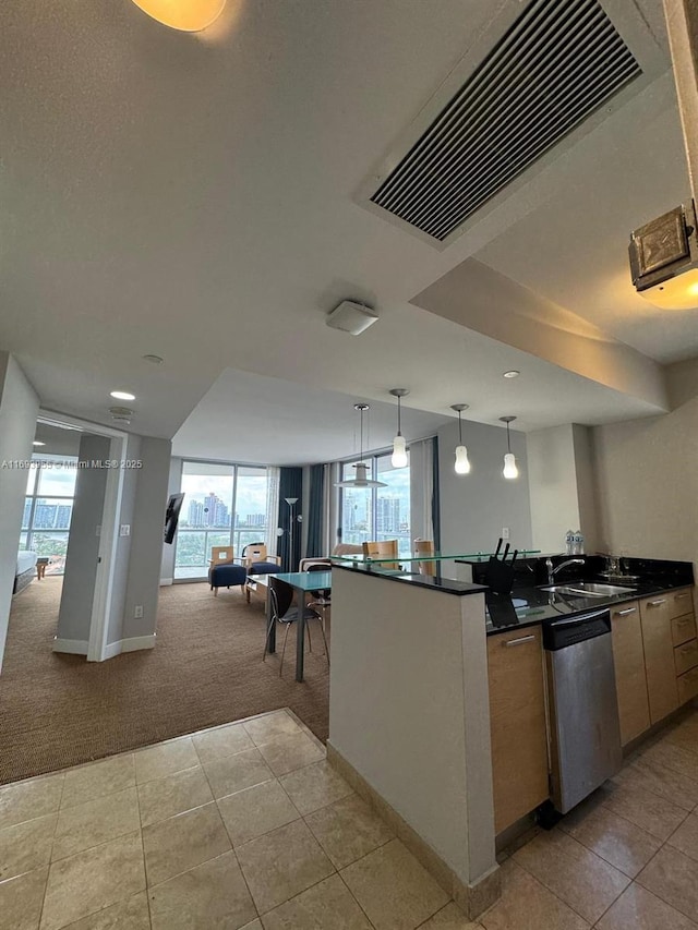 kitchen featuring light carpet, pendant lighting, a wealth of natural light, and stainless steel dishwasher