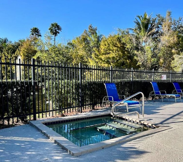 view of swimming pool with a community hot tub and a patio