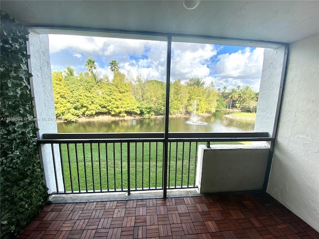 unfurnished sunroom featuring a water view