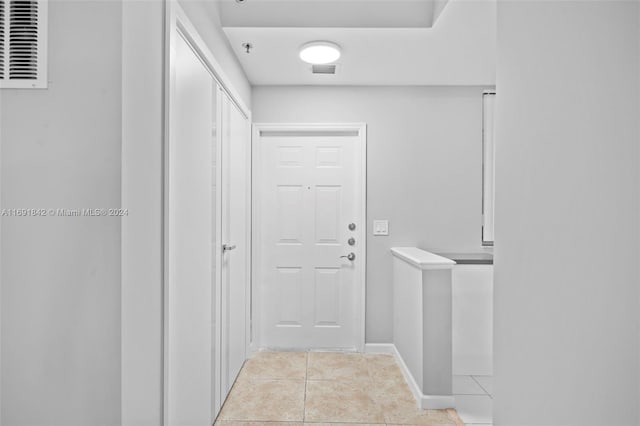 doorway to outside featuring light tile patterned floors