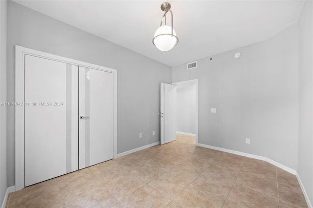 unfurnished bedroom with light tile patterned floors