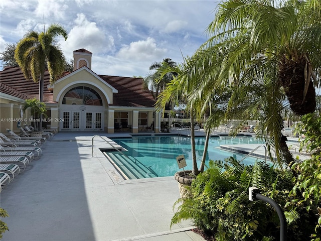 view of pool featuring french doors