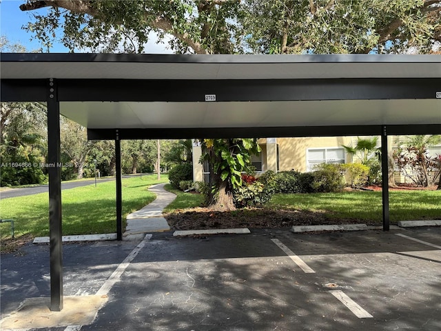 view of parking with a carport and a lawn