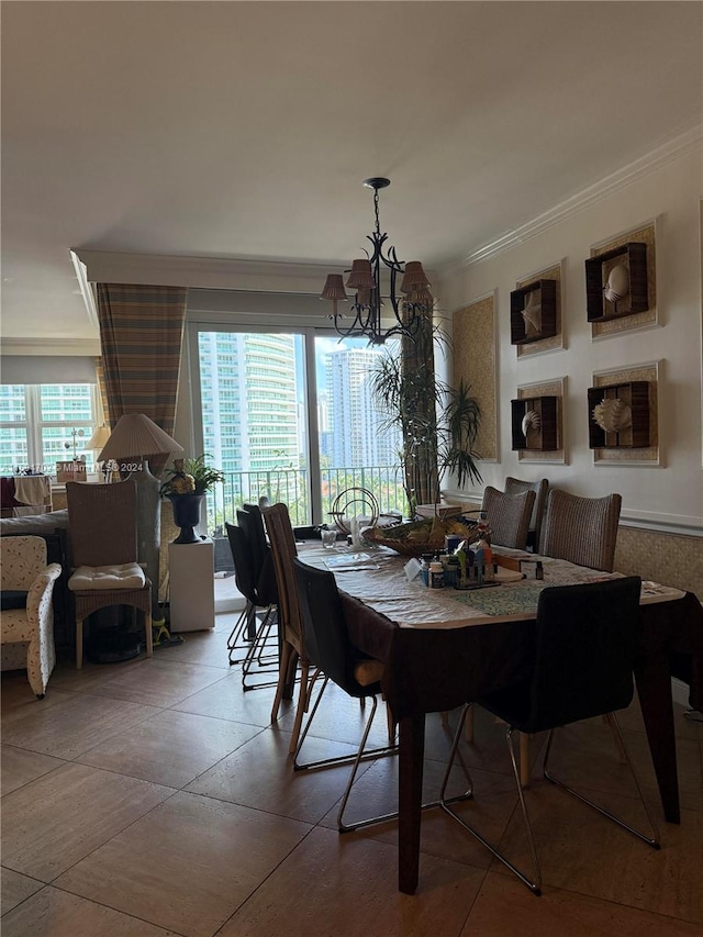 dining room with ornamental molding, an inviting chandelier, and a healthy amount of sunlight