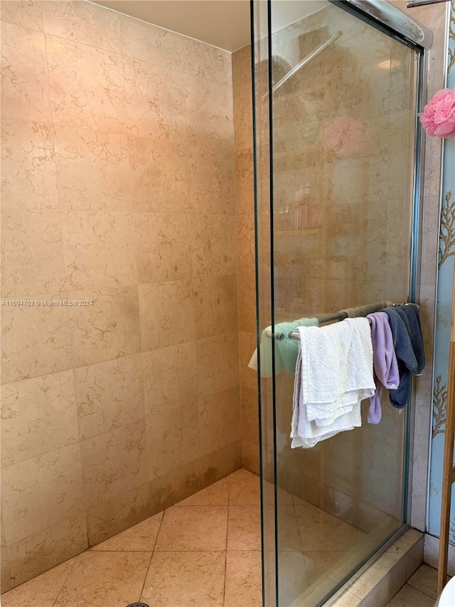 bathroom featuring a shower with shower door