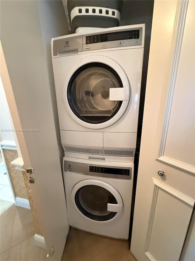 laundry room with stacked washer and dryer