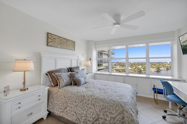 tiled bedroom featuring ceiling fan