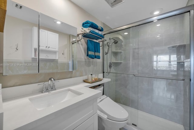 bathroom with vanity, toilet, and walk in shower