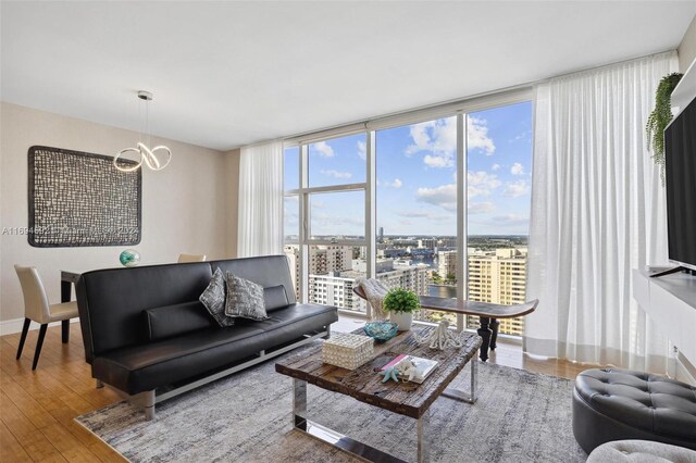 living room featuring expansive windows and hardwood / wood-style flooring